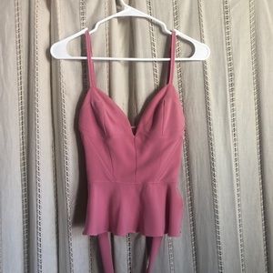 Pink corseted two-piece outfit with ties